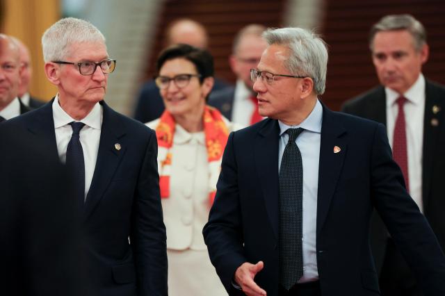 Nvidia CEO Jensen Huang 2-R and Apple CEO Tim Cook L arrive for the meeting between Chinese Premier Li Qiang and US business representatives at the Great Hall of the People in Beijing China 14 May 2026 EPAYonhap