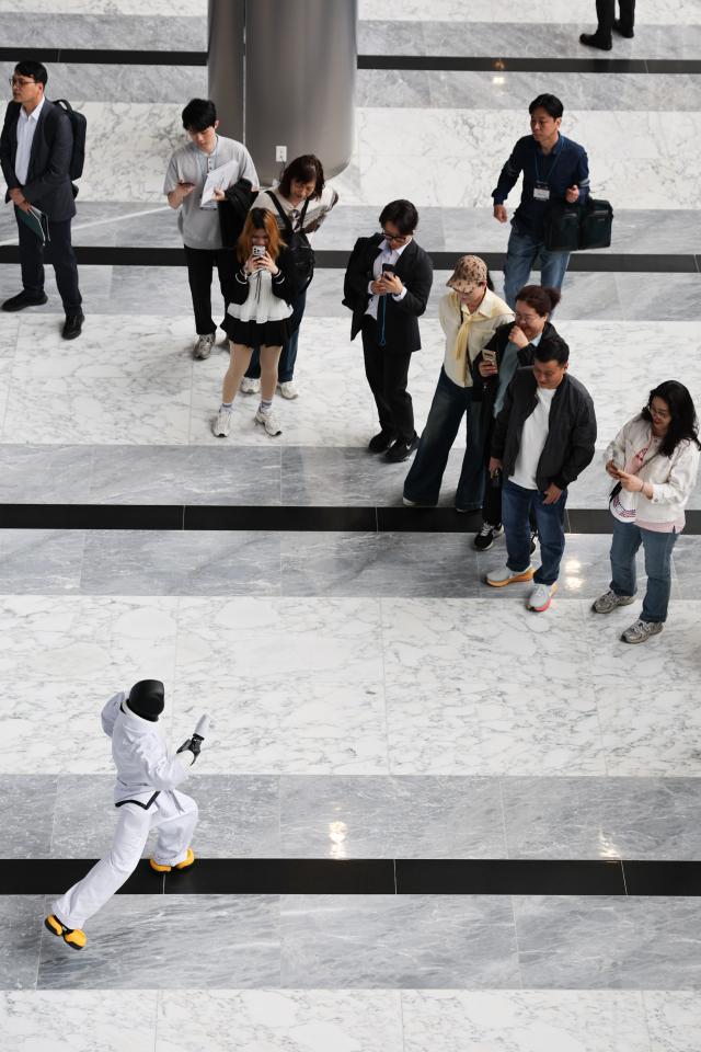 Spectators viewing a humanoid dance at the Autonomous Manufacturing AI World Show 2026 Yonhap