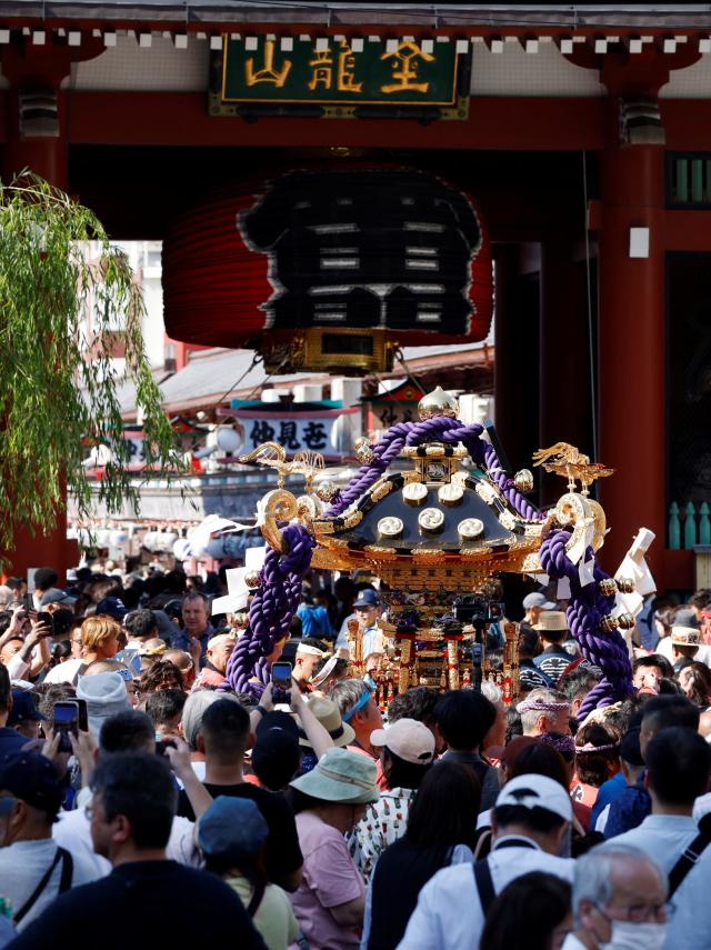 Revellers carry a Mikoshi a portable shrine in front of the Senso-ji Temple during the Sanja Matsuri or Sanja Festival one of the three largest Shinto festivals in Tokyo at Asakusa district in TokyoJapan May 17 2026 REUTERSYonhap