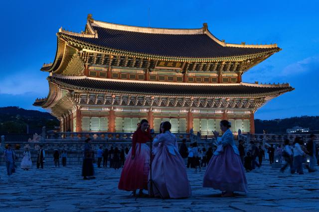 People view the illuminated Gyeongbokgung Palace during nighttime in Seoul South Korea 13 May 2026 The palace grounds are open for night tours from 13 May to 14 June 2026 EPAYonhap
