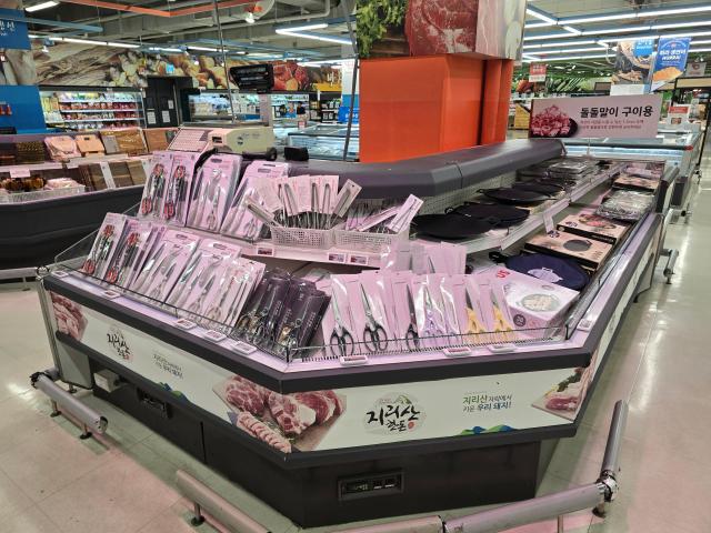 Pork counter stocked with wooden cutting boards and spoons at Homeplus Hwaseong Gyeonggi Province AJP Kim Dong-young