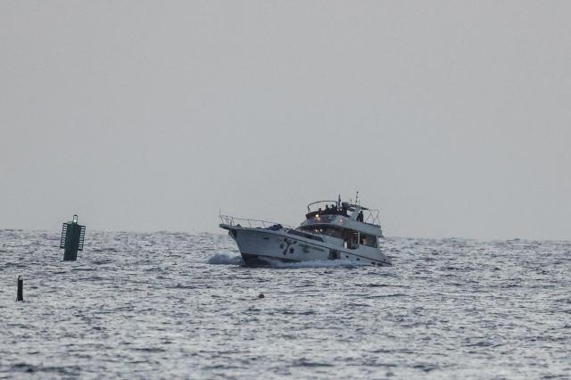 A boat bearing symbols of one of the vessels belonging to the Gaza-bound aid flotilla and intercepted by the Israeli navy is motored towards the Israeli port of Ashdod about 40 kilometres south of Tel Aviv on May 19 2026 AFPYonhap
