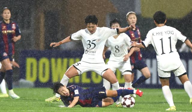 Suwon FC Women’s Park Hyun-jin lies on the ground after battling for the ball with Naegohyang Women’s Football Club’s An Bok-yong during their AFC Women’s Champions League semifinal match at Suwon Sports Complex in Suwon Gyeonggi Province on May 20 2026 Courtesy of Yonhap News Agency 