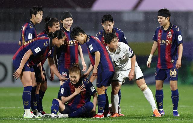 Naegohyang Women’s Football Club’s Choe Yon-a pats the back of Suwon FC Women’s Ayaka Nishikawa who is lying on the ground during the AFC Women’s Champions League semifinal match at Suwon Sports Complex in Suwon Gyeonggi Province on May 20 2026  Courtesy of Yonhap News Agency 