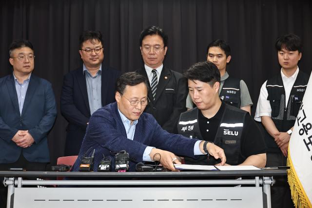20일 경기도 수원시 장안구 경기고용노동청에서 열린 삼성전자 임금협상을 마친 후 여명구 삼성전자 DS디바이스솔루션·반도체 사업 담당 피플팀장과 최승호 삼성그룹 초기업노동조합 삼성전자지부 위원장이 잠정 합의안에 서명하고 있다사진공동취재