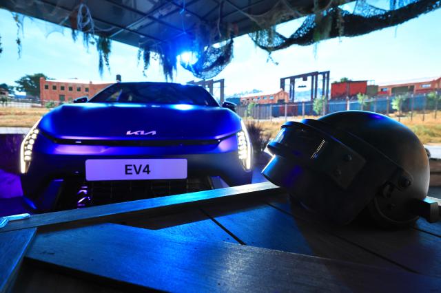 A Kia EV4 vehicle is displayed alongside PUBG-themed props at Kia Unplugged Ground in Seoul’s Seongsu district on May 22 2026