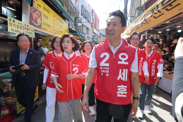 국민의힘 오세훈 서울시장 후보가 22일 서울 동작구 남성사계시장에서 나경원 의원과 함께 상인 및 시민들에게 인사를 하고 있다 사진연합뉴스
