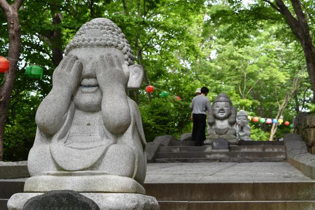 Stone figures marked with the Korean phrases “Do not hear” and “Do not speak” stand beside the trail at Hyangiram Hermitage in Yeosu South Jeolla Province on May 24 2026 AJP Joonha Yoo
