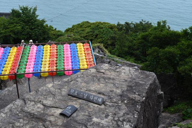 Colorful lanterns are seen near a cliff overlooking the sea at Hyangiram Hermitage in Yeosu, South Jeolla Province, on May 24, 2026. AJP Joonha Yoo