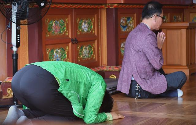 Visitors pray inside a hall at Hyangiram Hermitage in Yeosu, South Jeolla Province, on May 24, 2026. AJP Joonha Yoo