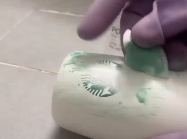 A consumer removes a Starbucks logo from a tumbler using nail polish remover in this image captured from a video posted on social media The video circulated online amid backlash over Starbucks Korea’s “Tank Day” marketing controversy Image captured from X  halosunny21