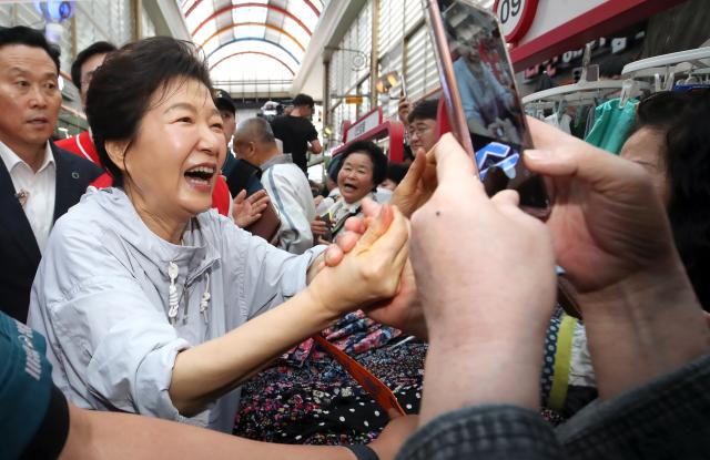 박근혜 전 대통령이 27일 경남 진주시 진주중앙시장에서 시민과 인사하고 있다 박 전 대통령은 이날 국민의힘 박완수 경남지사 후보 같은 당 한경호 진주시장 후보 등을 지지하기 위해 진주를 방문했다 사진연합뉴스