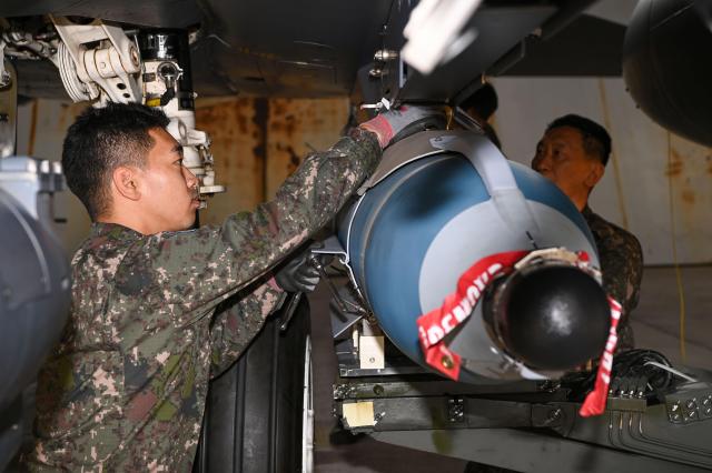 Air Force maintenance personnel load a GBU-56 air-to-ground guided bomb onto an F-15K fighter jet on May 20 2026 Courtesy of the Republic of Korea Air Force