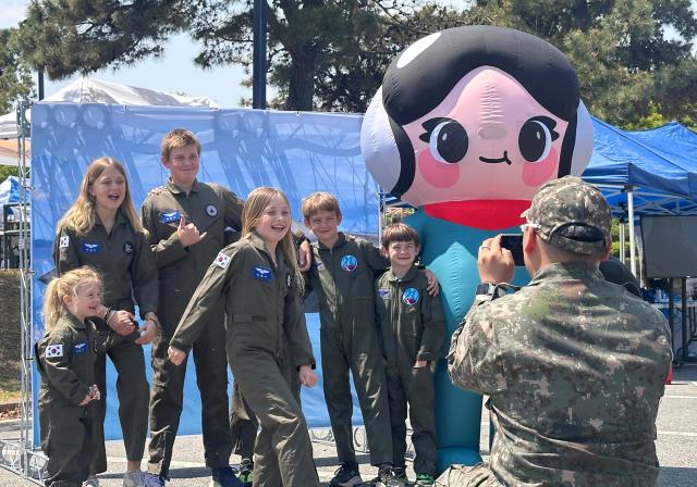 US Air Force family members stationed in South Korea pose for a photo during an event marking the ROK-US Alliance Strengthening Day at Osan Air Base in Osan south of Seoul on April 30 2026 Courtesy of the National Folk Museum of Korea 