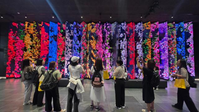 Participants Taking Photos at Freedom Hall's Memorial Wall