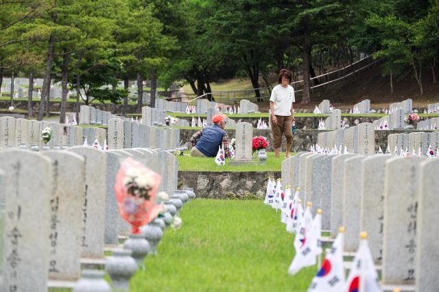 Citizens pay their respects at family graves during a visit to the Seoul National Cemetery in Seoul on June 1 2026 as South Korea marks the Month of Patriots and Veterans AJP Yoo Na-hyun