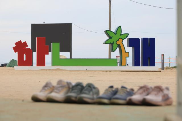 Shoes left by visitors line the edge of the tidal flats at Hanagae Beach in Jung-gu Incheon on June 1 2026