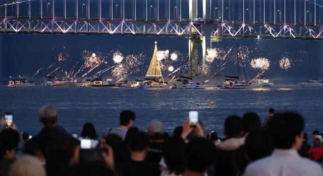 Fireworks are set off from a yacht during a drone performance at Gwangalli Beach in Busan on May 23.