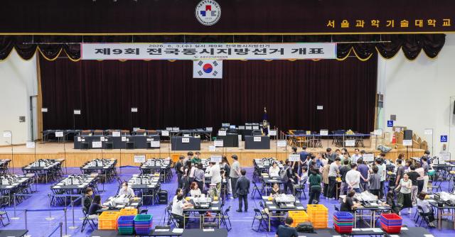 Officials demonstrate a ballot sorting machine at a vote-counting center set up inside the gymnasium of Seoul National University of Science and Technology in Seoul on June 2 2026 one day before South Koreas ninth nationwide local elections AJP Yoo Na-hyun