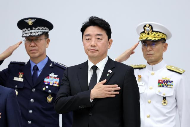 Kang Hoon-sik center presidential chief of staff salutes the national flag during a ceremony for the mutual repatriation of the remains of Korean War soldiers between South Korea and the United States at Seoul Air Base in Seongnam on June 5 2026 Yonhap 