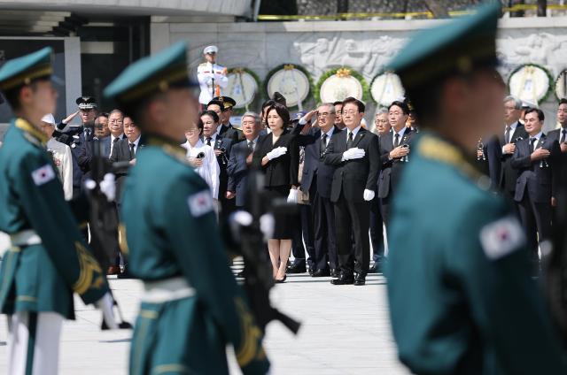 President Lee Jae Myung and first lady Kim Hye-kyung salute the national flag after paying tribute at the Memorial Tower during the 71st Memorial Day ceremony at Seoul National Cemetery in Dongjak District Seoul on June 6 2026 Yonhap