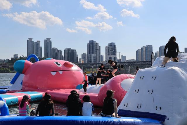 Visitors enjoy Hachi Island a floating aquatic playground shaped like Seouls official mascot at the 2026 My Pace Hangang Triathlon Festival held at Ttukseom and Jamsil Han River Parks in Seoul on June 5 2026 AJP Han Jun-gu