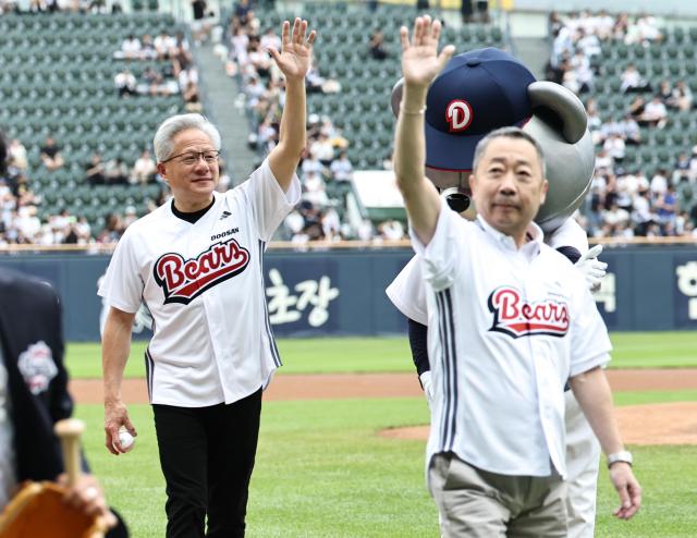 NVIDIA CEO Jensen Huang greets Park Jung-won, Chairman of Doosan Group, after throwing the first pitch at the KBO League game between Kiwoom Heroes and Doosan Bears on June 7, 2026, at Seoul's Jamsil Baseball Stadium. Photo: Yonhap News