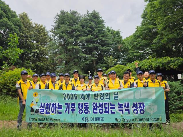 Employees from OB Beer's Gwangju factory pose for a photo after completing a river cleanup on June 4.