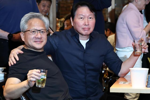 Nvidia CEO Jensen Huang and SK Group Chairman Chey Tae-won raise their glasses during a gathering at a Kkanbu Chicken restaurant in Seouls Gangnam District on June 7 2026 Yonhap