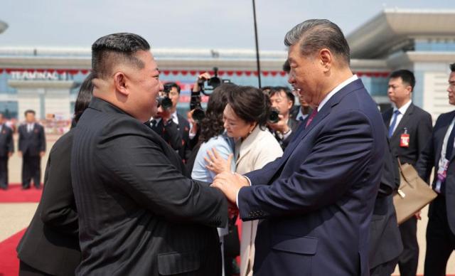 North Korean leader Kim Jong-un left shakes hands with Chinese President Xi Jinping before Xis departure at Pyongyang Sunan International Airport on June 9 2026 in this photo released by the state-run North Korean Central News Agency KCNA the following day