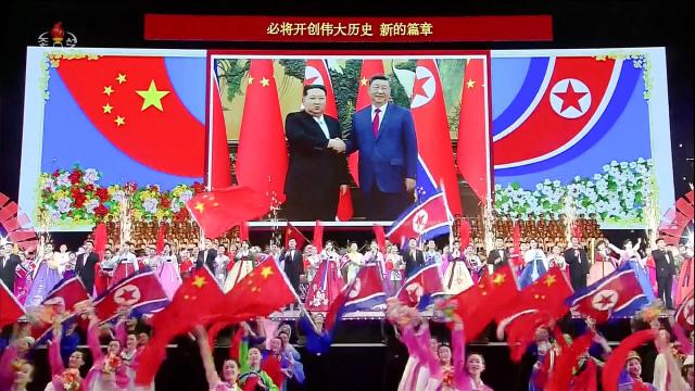 Performers wave Chinese and North Korean flags during a welcoming performance for Chinese President Xi Jinping’s state visit to North Korea at Pyongyang Gymnasium on June 8 2026 in this image captured from Korean Central Television