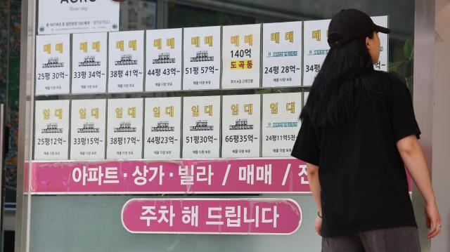 Real estate listing information posted at a real estate agency in Gangnam, Seoul on June 8