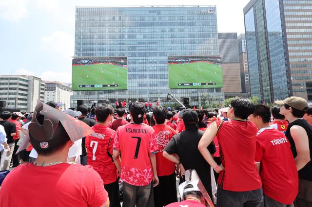 Fans in red jerseys watch South Koreas 2026 FIFA World Cup group-stage match against Czechia on outdoor screens at Gwanghwamun Square in central Seoul on Friday AJP Yoo Na-hyun