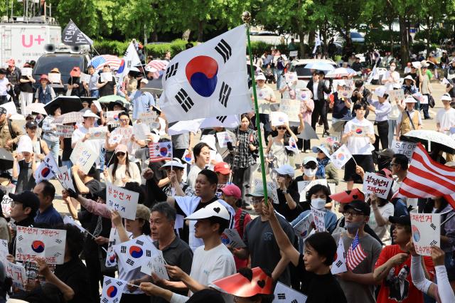 Citizens gather outside the vote-counting center at the Olympic Handball Gymnasium in Seouls Songpa district on June 8 2026 chanting slogans calling for a rerun of the June 3 local elections following the ballot paper shortage controversy AJP Han Jun-gu
