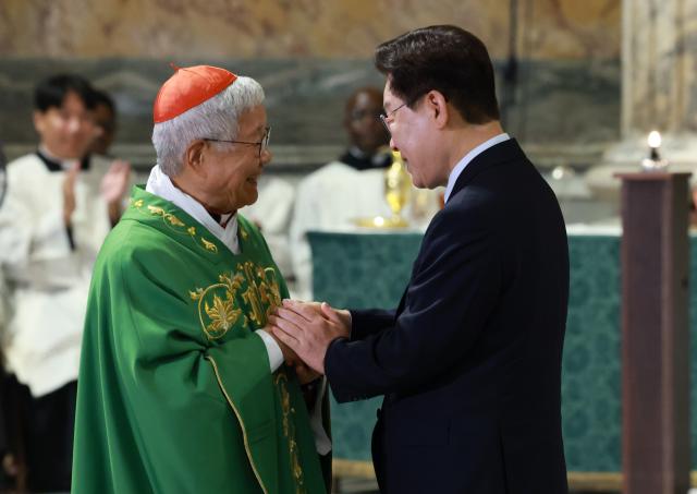 President Lee Jae-myung greets Cardinal Yoo Heung-sik after delivering a commemorative speech at the Special Mass for Peace and Solidarity at St. Paul Outside the Walls in Rome on June 14, 2026.