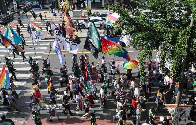 Participants take part in the 27th Seoul Queer Parade near Euljiro 1-ga Station in central Seoul on June 13, 2026. 

