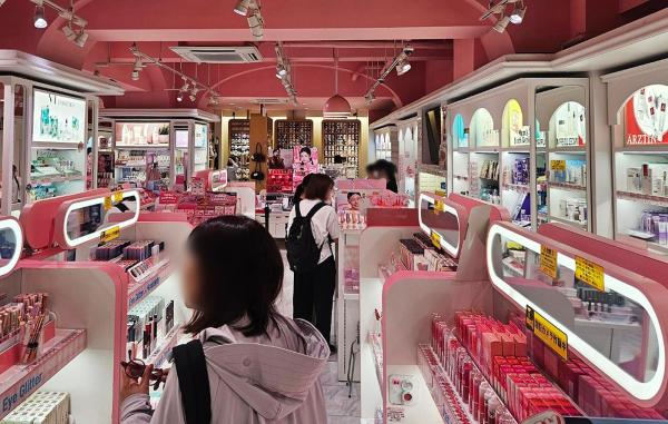 Japanese women purchasing Korean cosmetics at a store in Shinjuku, Tokyo.
