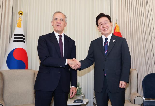 South Korean President Lee Jae Myung and Canadian Prime Minister Mark Carney shake hands ahead of their bilateral meeting at the venue of the Group of Seven G7 Summit in Evian-les-Bains France on June 16 2026 local time Yonhap 