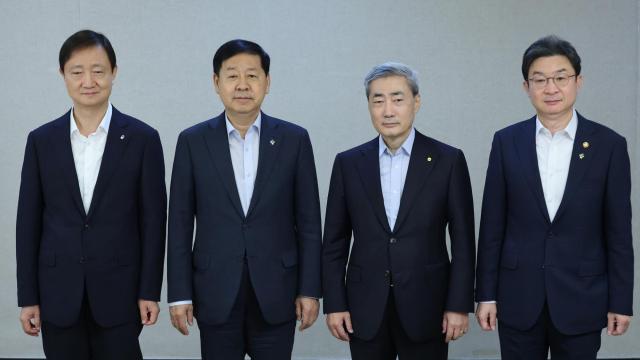 from left Financial Supervisory Service Governor Lee Chan-jin Deputy Prime Minister and Minister of Finance and Economy Koo Yun Cheol Bank of Korea Governor Shin Hyun Song and Financial Services Commission Chairman Lee Eog-weon pose for a photo during an expanded macroeconomic and financial policy meeting at the Government Complex Seoul in Jongno District Seoul on June 18 Yonhap