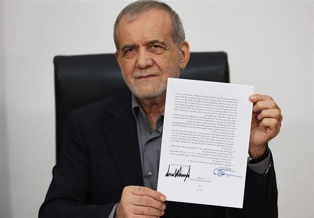 A handout from the Telegram account of the Islamic Republic of Iran Broadcasting IRIB on June 18 2026 shows Irans President Masoud Pezeshkian holding a document showing a memorandum of understanding he signed to end the Middle East war AFP-Yonhap