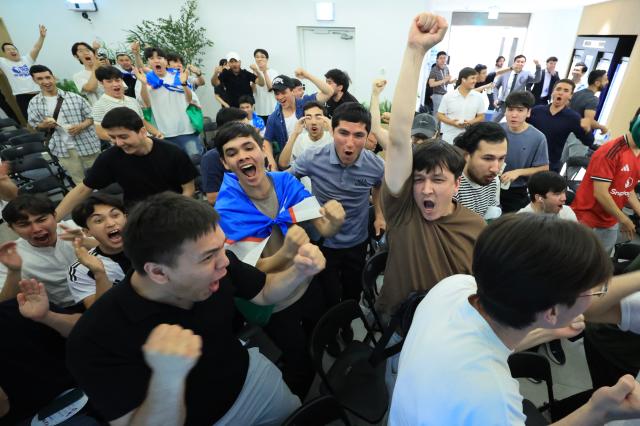 Uzbekistani residents in South Korea cheer after their national team scores during a World Cup match at the basement of S Tower in Seongsu-dong Seongdong-gu Seoul on June 18 2026 AJP Han Jun-gu