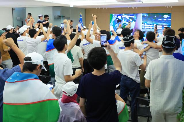 Uzbekistani residents in South Korea cheer for their countrys World Cup match on a screen at the basement of S Tower in Seongsu-dong Seongdong-gu Seoul on June 18 2026 AJP Han Jun-gu