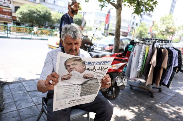 A man reads a copy of the Iranian daily newspaper Hamshahri bearing an image of the US president and a headline that reads Gone with the wind at a kiosk in Tehran on June 18 2026 The United States and Iran have signed a deal to end the Middle East war with a ceremony set for June 19 in Switzerland that will mark the start of a 60-day negotiation period The memorandum of understanding aims to put an end to months of conflict initiated by US-Israeli strikes on Iran in February which wreaked chaos across the region and rattled the global economy AFP-Yonhap 