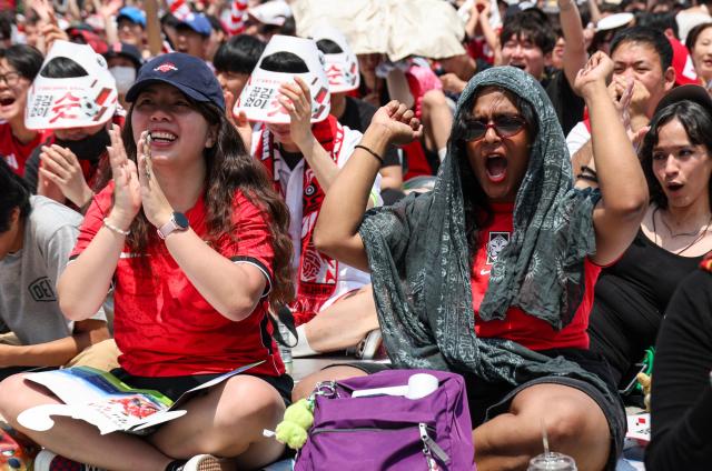 Supporters cheer while watching South Koreas Group A match against the Czechia Republic during a public viewing event for the 2026 FIFA World Cup at Gwanghwamun Square in Seoul on June 12 AJP Yoo Na-hyun