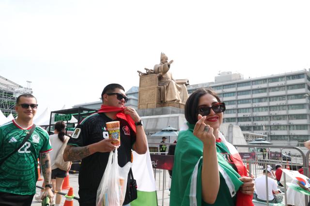 Mexicans wearing a Mexico jersey poses for a photograph at Gwanghwamun Square in central Seoul before South Koreas Group A match against Mexico at the 2026 FIFA World Cup on Thursday AJP Yoo Na-hyun