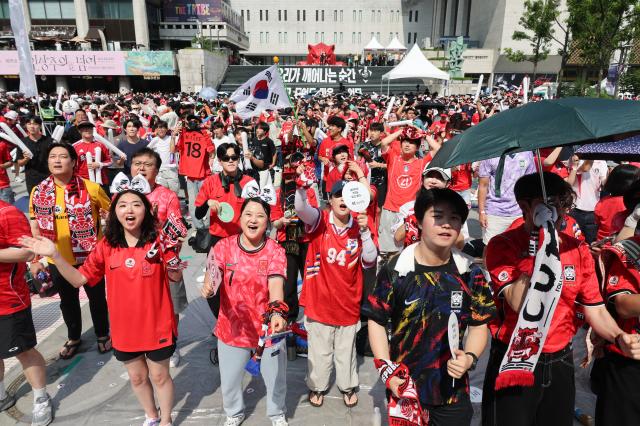Citizens cheer on the streets during the match between South Korea and Mexico on June 19 at Gwanghwamun Square in Seoul, part of the 2026 North and Central America World Cup group stage.