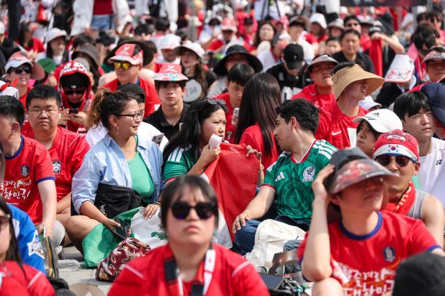 South Korean football fans cheer while watching the Group A match between South Korea and Mexico at a public viewing event at Gwanghwamun Square in Seoul on June 19 2026 during the 2026 FIFA World Cup AJP Yoo Na-hyun