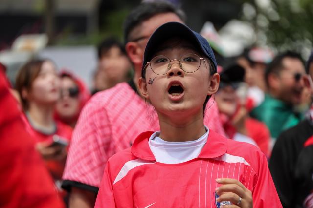 South Korean football fans cheer while watching the Group A match between South Korea and Mexico at a public viewing event at Gwanghwamun Square in Seoul on June 19 2026 during the 2026 FIFA World Cup AJP Yoo Na-hyun
