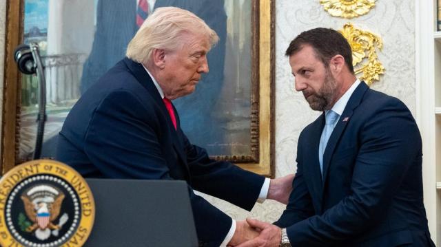 Secretary of Homeland Security Merlin shaking hands with President Donald Trump