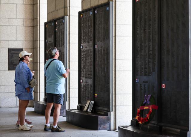 A foreign visitor traces names on the Memorial Wall at the War Memorial of Korea in Yongsan-gu Seoul on June 23 2026 AJP Yoo Na-hyun